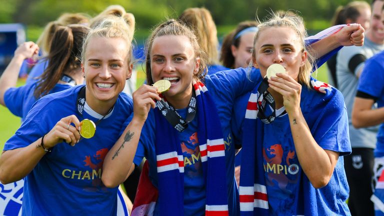 Rangers players celebrate with their winners' medals