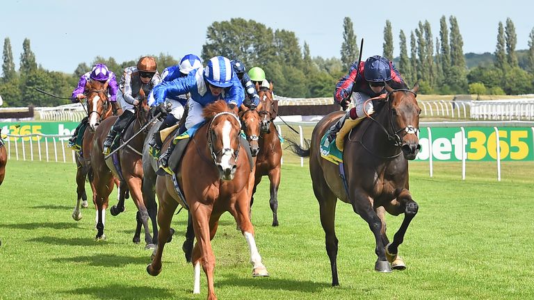 Tabdeed (blue and white) wins the Hackwood Stakes at Newbury