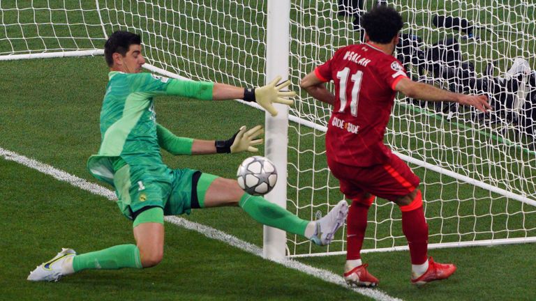 Real Madrid goalkeeper Thibaut Courtois saves from Liverpool's Mohamed Salah