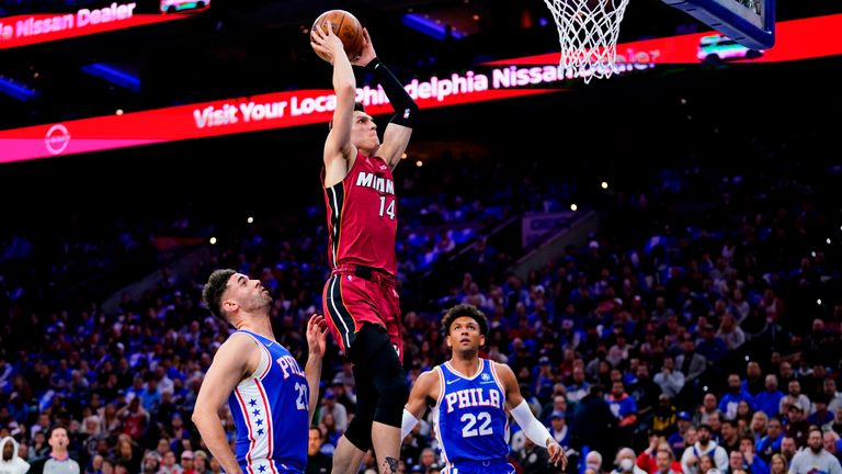 Miami Heat&#39;s Tyler Herro, center, goes up for a shot against Philadelphia 76ers&#39; Georges Niang and Matisse Thybulle during the first half of Game 3 of an NBA basketball second-round playoff series, Friday, May 6, 2022, in Philadelphia. (AP Photo/Matt Slocum)