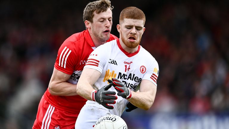 Cathal McShane of Tyrone in action against Brendan Rogers of Derry