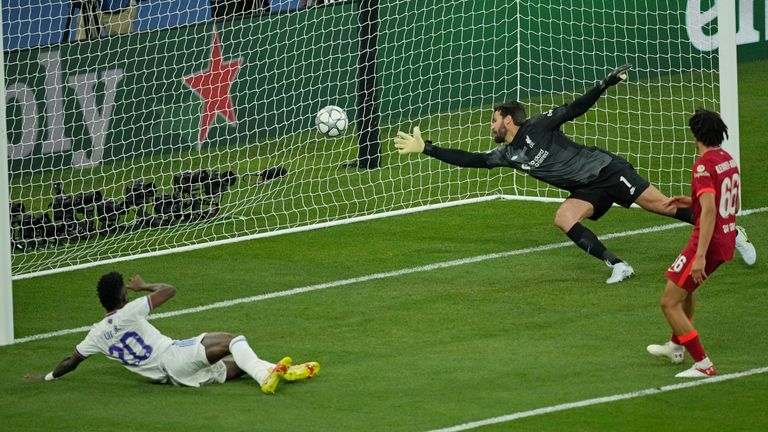 Real Madrid's Vinicius Junior, left, scores his side's opening goal during the Champions League final soccer match between Liverpool and Real Madrid at the Stade de France in Saint Denis near Paris, Saturday, May 28, 2022. (AP Photo/Christophe Ena)