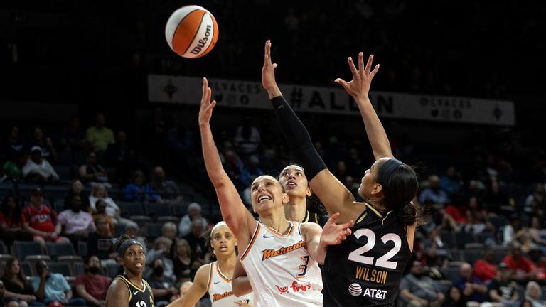 Phoenix Mercury guard Diana Taurasi (3) shoots against Las Vegas Aces forward A & # 39; ja Wilson (22) during the second half of a WNBA basketball game, Saturday, May 21, 2022, in Las Vegas.  Aces guard Chelsea Gray (12), Mercury forward Brianna Turner, second from right, and Aces forward Dearica Hamby, behind center, watch the ball.