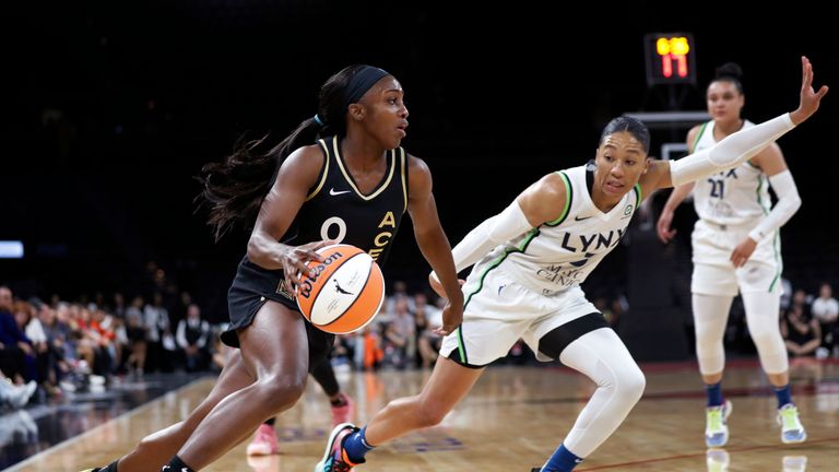 Las Vegas Aces guard Jackie Young (0) drives past Minnesota Lynx forward Aerial Powers (3) during a WNBA basketball game in Las Vegas on Thursday, May 19, 2022.