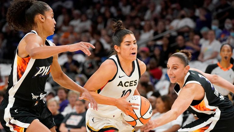 Las Vegas Aces&#39; Kelsey Plum (10) drives to the basket between Phoenix Mercury&#39;s Skyler Diggins-Smith, left, and Diana Taurasi, right, during the first half of a WNBA basketball game Friday, May 6, 2022, in Phoenix. (AP Photo/Darryl Webb)