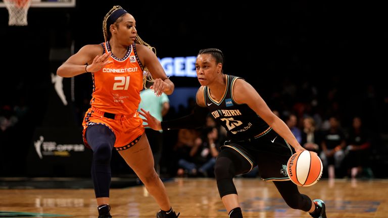 New York Liberty guard Asia Durr (25) drives past Connecticut Sun guard/forward DiJonai Carrington (21) in the first half during a WNBA basketball game, Saturday, May 7, 2022, in New York.
