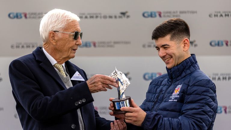 Lester Piggott (left) hands over the Championship apprentice trophy to Marco Ghiani