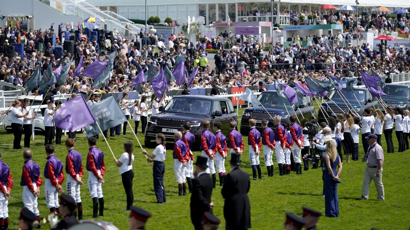 Spectacular sight at Epsom as Queen’s jockeys form guard of honour