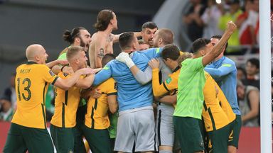 Andrew Redmayne is mobbed by Australia's players after his penalty shoot-out save sends them to Qatar 2022