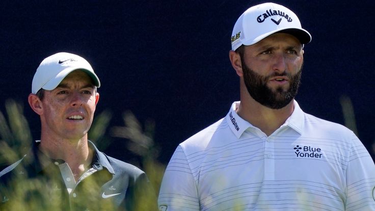 Rory McIlroy, left, of Northern Ireland, and Jon Rahm, of Spain, talk before teeing off at the fifth hole at The Country Club, Monday, June 13, 2022, in Brookline, Mass., during a practice round ahead of the U.S. Open golf tournament. (AP Photo/Robert F. Bukaty)