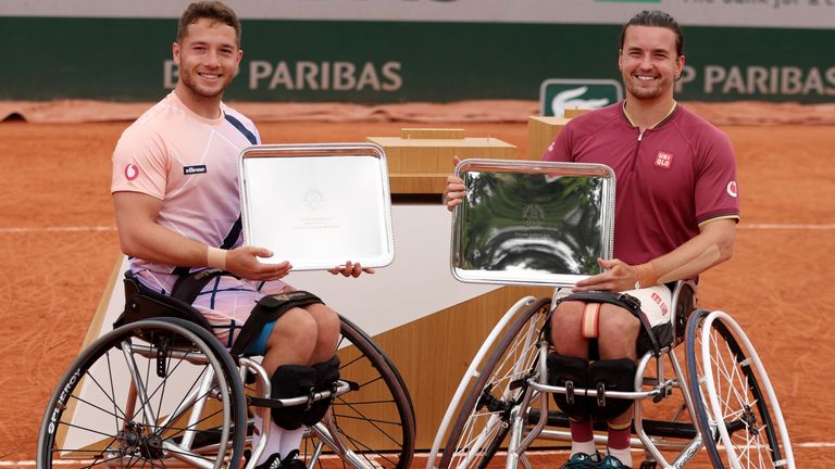 Alfie Hewett of Great Britain (L) and partner Gordon Reid of Great Britain celebrate with the trophy after winning against Gustavo Fernandez of Argentina and Shingo Kunieda of Japan during the Men's Wheelchair Doubles Final match on Day 15 of The 2022 French Open at Roland Garros on June 05, 2022 in Paris, France. (Photo by Clive Brunskill/Getty Images)