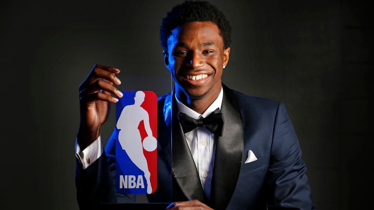 Andrew Wiggins poses with the 2014-15 NBA Rookie of the Year trophy