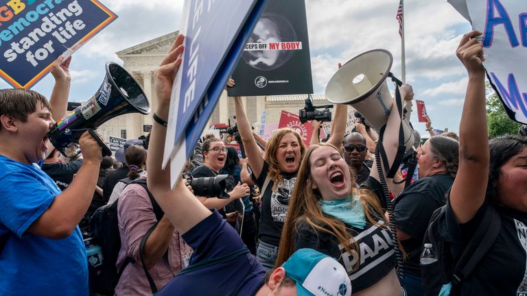 Anti-abortion protesters celebrate following Supreme Court&#39;s decision to overturn Roe v. Wade, federally protected right to abortion, in Washington, Friday, June 24, 2022. (AP Photo/Gemunu Amarasinghe)