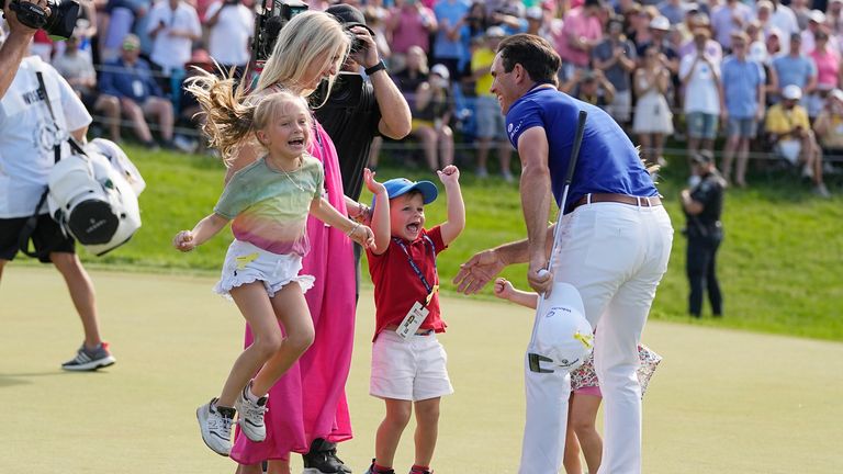 Billy Horschel celebrates with his family on the 18th green after winning the Memorial Tournament