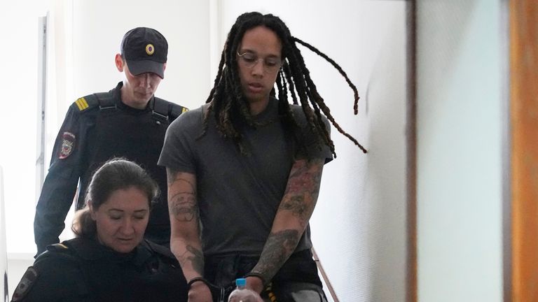 WNBA star and two-time Olympic gold medalist Brittney Griner is escorted to a courtroom for a hearing, in Khimki just outside Moscow, Russia, Monday, June 27, 2022. More than four months after she was arrested at a Moscow airport for cannabis possession, American basketball star Brittney Griner is to appear in court Monday for a preliminary hearing ahead of her trial. (AP Photo/Alexander Zemlianichenko)