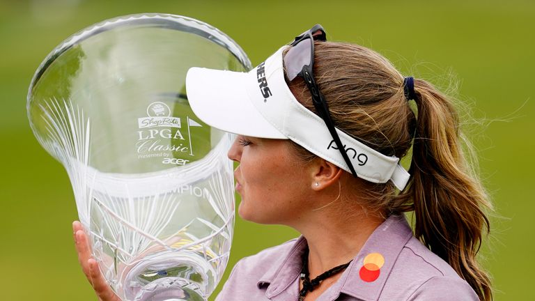 Brooke M. Henderson, of Canada, kisses the trophy after winning the ShopRite LPGA Classic golf tournament, Sunday, June 12, 2022, in Galloway, N.J. (AP Photo/Matt Rourke)