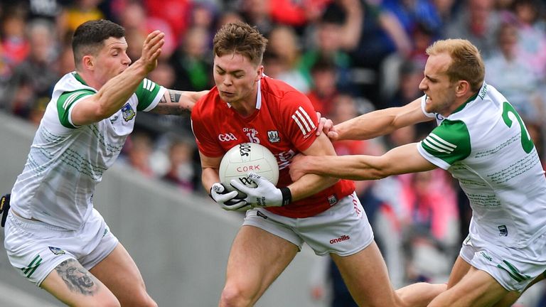 12 June 2022; Cathail O'Mahony of Cork is tackled by Iain Corbett, left, and Sean O'Dea of Limerick during the GAA Football All-Ireland Senior Championship Round 2 match between between Cork and Limerick at P..irc Ui Chaoimh in Cork. Photo by E..in Noonan/Sportsfile