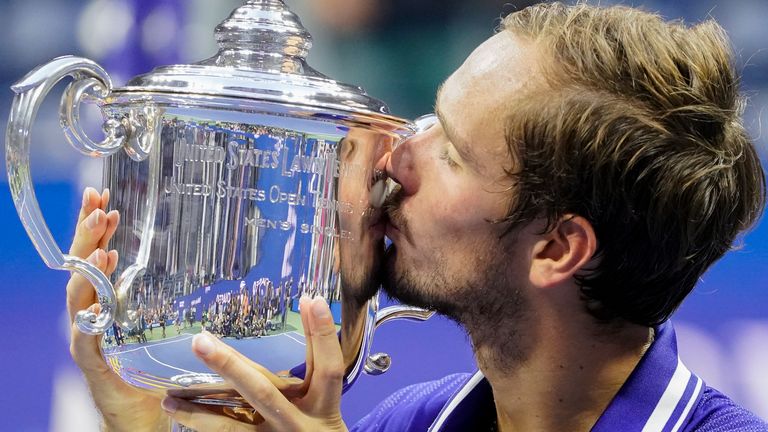Daniil Medvedev, of Russia, kisses the championship trophy after defeating Novak Djokovic, of Serbia, in the men&#39;s singles final of the U.S. Open tennis championships, Sunday, Sept. 12, 2021, in New York. The U.S. Open tennis tournament will allow players from Russia and Belarus to compete this year despite the ongoing invasion of Ukraine that prompted a ban at Wimbledon.(AP Photo/John Minchillo, File)