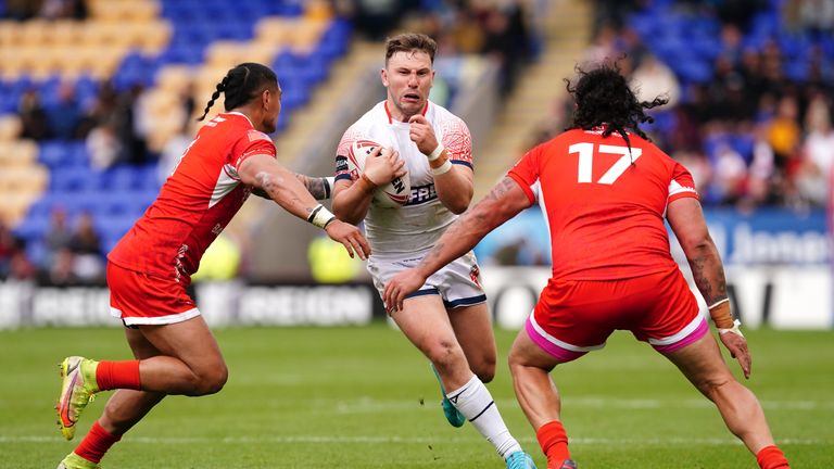 England�s George Williams is tackled by Combined Nations Allstars XIII�s Peter Mata�utia (left) and David Fifita during the Mid-Season International match at the Halliwell Jones Stadium, Warrington. Picture date: Saturday June 18, 2022.