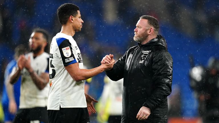 Derby County manager Wayne Rooney (right) and Curtis Davies shake hands after the final whistle in the Sky Bet Championship match at Cardiff City Stadium, Cardiff.  Picture date: Tuesday March 1, 2022.