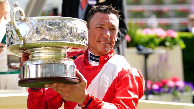 Frankie Dettori lifts the Coronation Stakes trophy after his winning ride on Inspiral