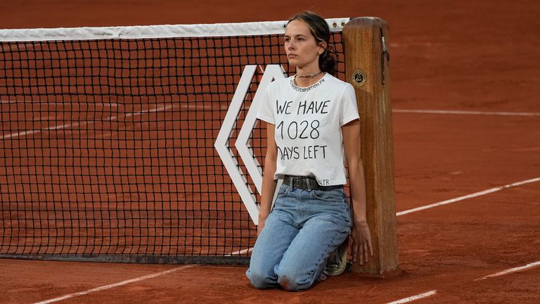 The semi-final was held up for 10 minutes after a woman invaded the court and tied herself to the net
