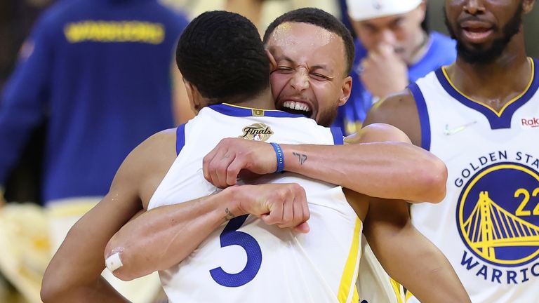 Golden State Warriors guard Jordan Poole, left, celebrates with guard Stephen Curry after scoring against the Boston Celtics in Game 2
