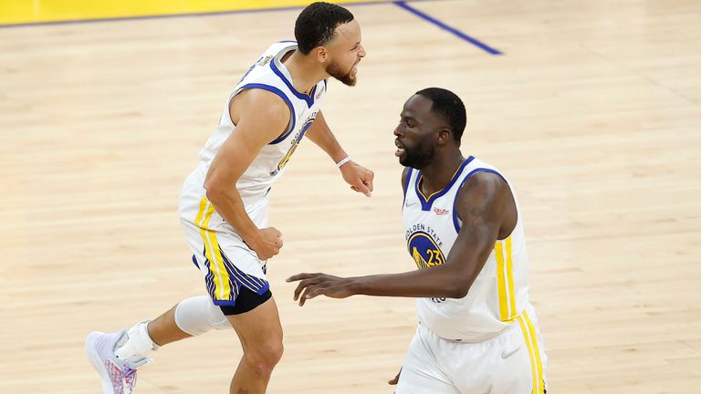 Golden State Warriors guard Stephen Curry, left, celebrates with forward Draymond Green during the first half of Game 1 of basketball's NBA Finals against the Boston Celtics in San Francisco