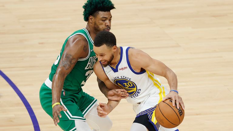 Golden State Warriors guard Stephen Curry, right, attempts to drive to the basket against Boston Celtics guard Marcus Smart during Game 2 of the NBA Finals