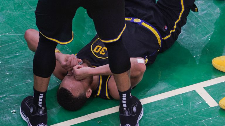 Golden State Warriors guard Stephen Curry is left on the floor following in the scrum late in Game 3