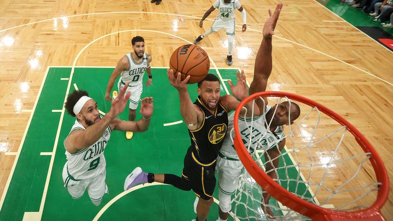 Golden State Warriors guard Stephen Curry (30) goes up for a shot against Boston Celtics center Al Horford (42) and guard Derrick White (9) during Game 4 of basketball&#39;s NBA Finals, Friday, June 10, 2022, in Boston.