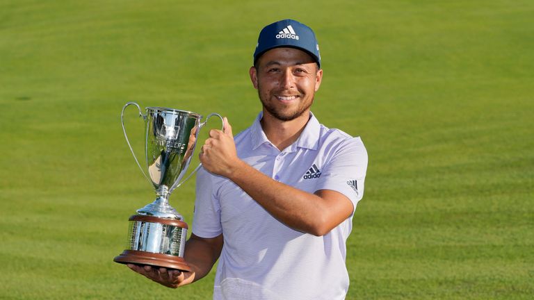 Xander Schauffele holds the trophy after winning the Travelers Championship golf tournament at TPC River Highlands, Sunday, June 26, 2022, in Cromwell, Conn.