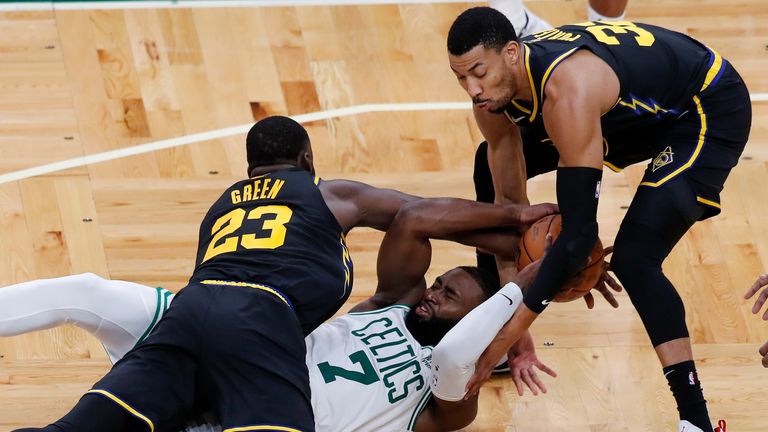 Boston Celtics guard Jaylen Brown scrambles for a loose ball against Golden State Warriors forward Draymond Green and forward Otto Porter Jr. during the second half of Game 3
