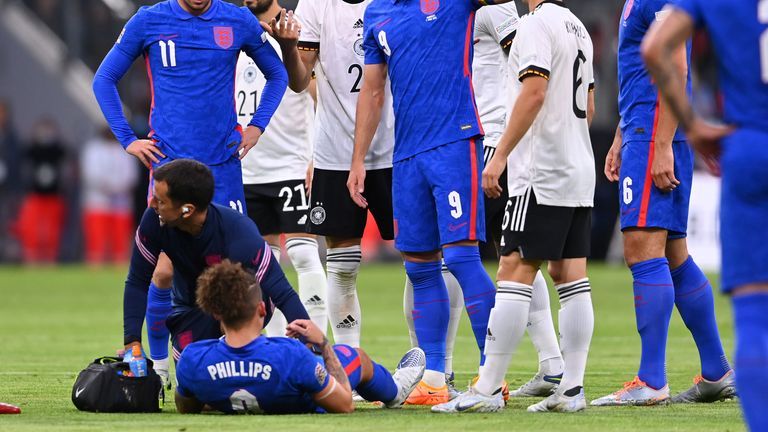 England's Kalvin Phillips lies on the pitch in pain during the UEFA Nations League soccer match between Germany and England at the Allianz Arena, in Munich, Germany, Tuesday, June 7, 2022. (AP Photo/Markus Ulmer)