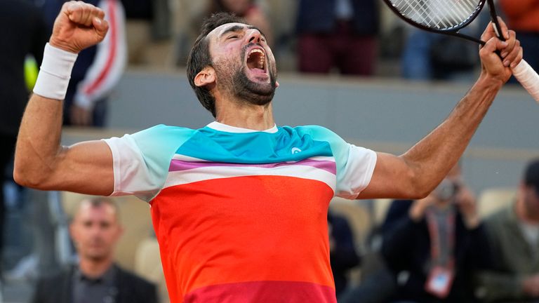 Croatia's Marin Cilic celebrates winning his quarterfinal match against Russia's Andrey Rublev in five sets, 5-7, 6-3, 6-4, 3-6, 7-6 (10-2), at the French Open tennis tournament in Roland Garros stadium in Paris, France, Wednesday, June 1, 2022. (AP Photo/Michel Euler)