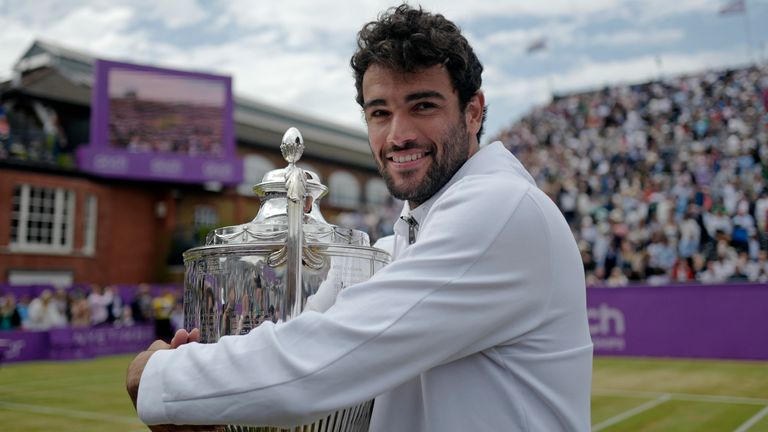 Italy's Matteo Berrettini celebrates with the trophy after beating Serbia's Filip Krajinovic to win the final tennis match at the Queen's Club Championships in London, Sunday, June 19, 2022. (AP Photo/Alberto Pezzali)
