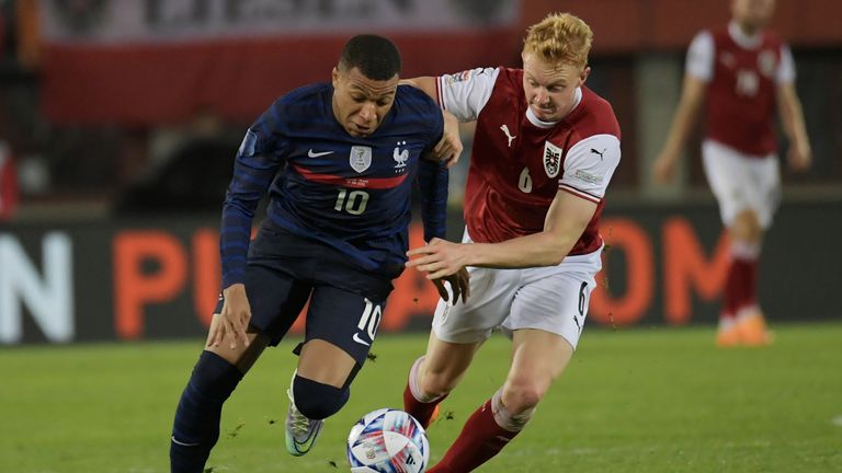 France's Kylian Mbappe, left, and Austria's Nicolas Seiwald challenge for the ball during the UEFA Nations League soccer match between between Austria and France at the Ernst Happel Stadion in Vienna, Austria, Friday, June 10, 2022. (AP Photo/Michael Gruber)