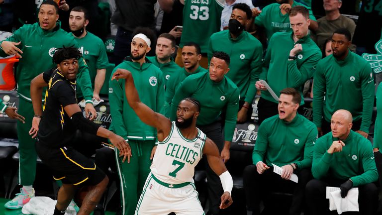 Boston Celtics guard Jaylen Brown (7) reacts as he shoots a three-point shot against the Golden State Warriors during the first quarter of Game 3 of basketball&#39;s NBA Finals, Wednesday, June 8,