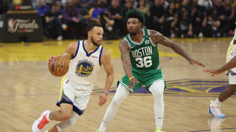 Golden State Warriors guard Stephen Curry drives to the basket against Boston Celtics guard Marcus Smart during the first half of Game 2 of basketball&#39;s NBA Finals in San Francisco, Sunday, June 5, 2022.