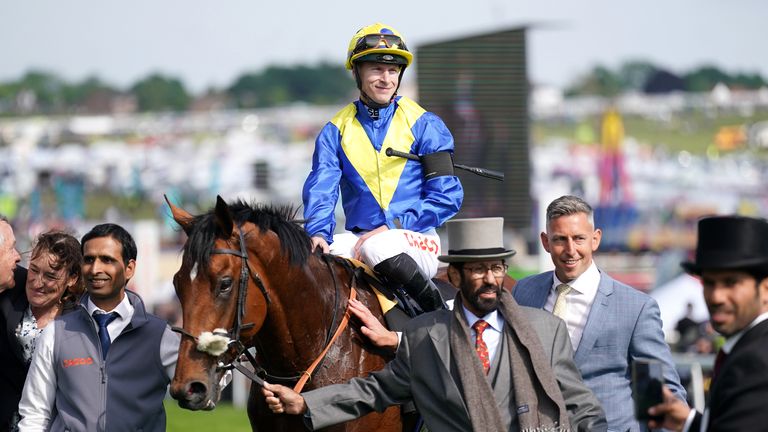 Richard Kingscote is led back past the Epsom crowd after Desert Crown's victory in the 2022 Cazoo Derby