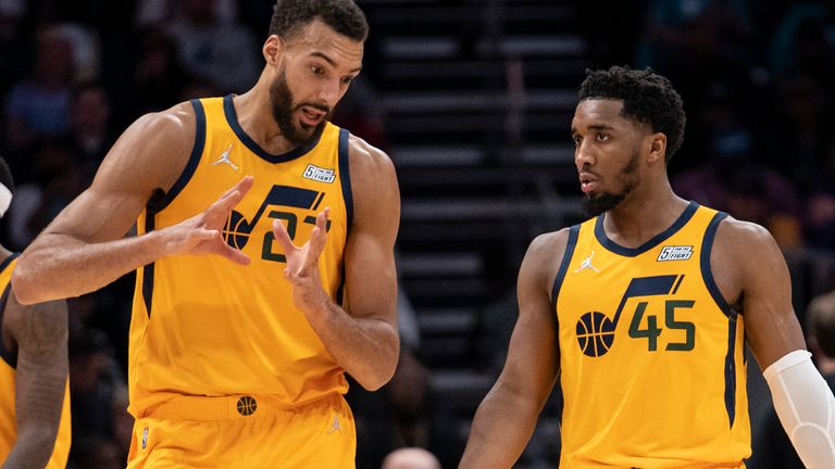 Utah Jazz center Rudy Gobert (left) and teammate Utah Jazz guard Donovan Mitchell (45) have a discussion during the second half of an NBA basketball game against the Charlotte Hornets, Friday, March 25, 2022, in Charlotte, N.C. (AP Photo/Matt Kelley)