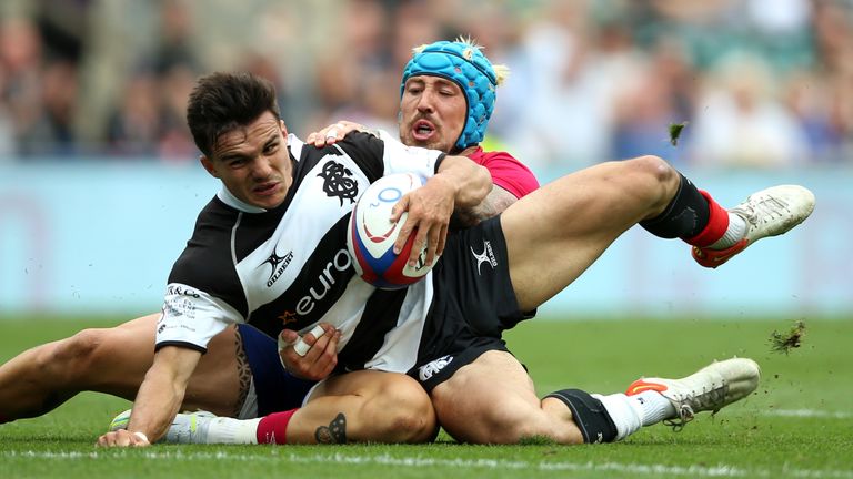 Barbarians' Max Spring scores a try under pressure from England's Jack Nowell