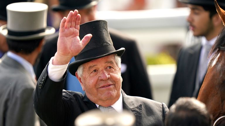 Sir Michael Stoute salutes someone in the crowd after winning a sixth Derby with Desert Crown