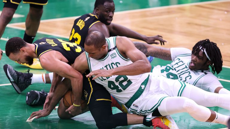 Golden State Warriors guard Stephen Curry, left, is caught under Boston Celtics big man Al Horford during the fourth quarter of Game 3