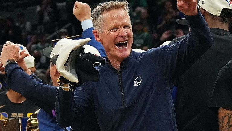 Golden State Warriors head coach Steve Kerr smiles and celebrates on stage after winning Game 6 of the 2022 NBA Finals 