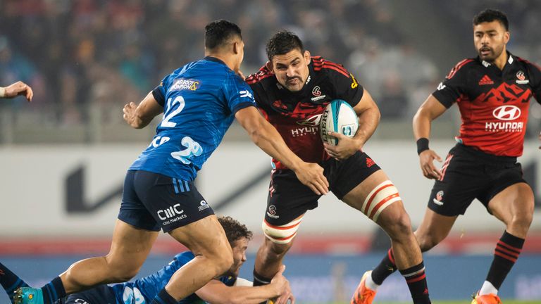 Crusaders Pablo Matera, center, runs at Roger Tuivasa-Sheck of the Blues during the Super Rugby Pacific final rugby match between the Auckland Blues and the Canterbury Crusaders at Eden Park in Auckland, New Zealand, Saturday, June 18, 2022.