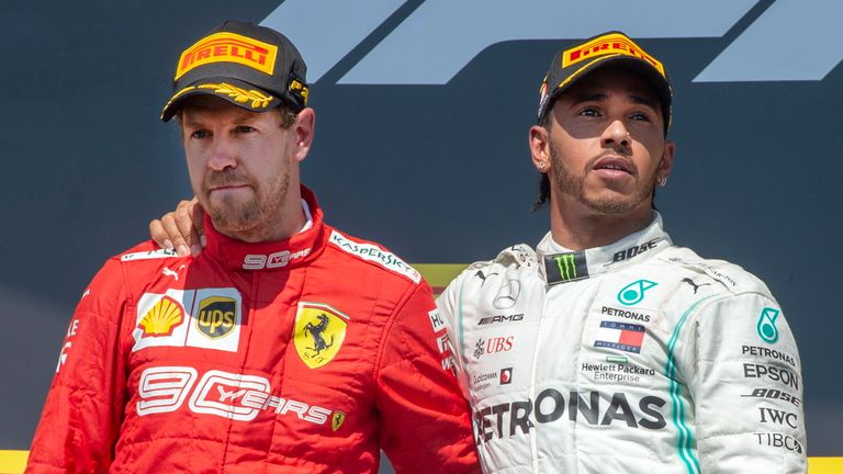 Mercedes driver Lewis Hamilton, right, of Britain, consoles Ferrari driver Sebastian Vettel, of Germany, after Hamilton won the Formula One Canadian Grand Prix auto race Sunday, June 9, 2019 in Montreal. Vettel finished first but was assessed a penalty to end up in second place.