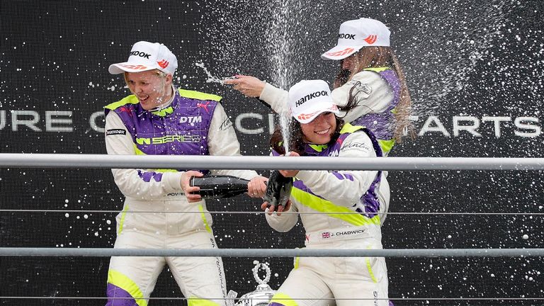 Jamie Chadwick, center, celebrates with Alice Powell, left, and Marta Garcia after she wins the inaugural car race of the new all-female W Series