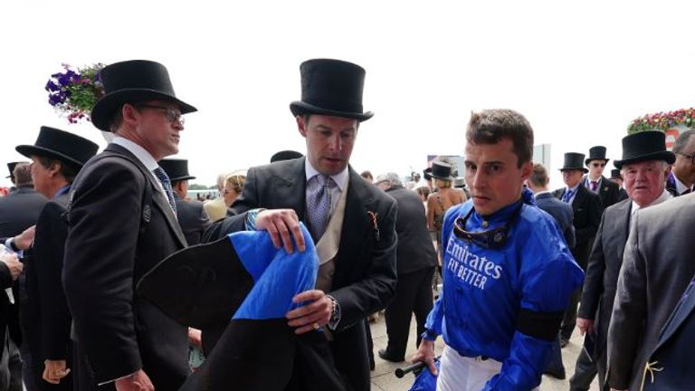 William Buick heads back into the weighing room to be assessed after getting a bump on the head for a horse in the stalls at Epsom