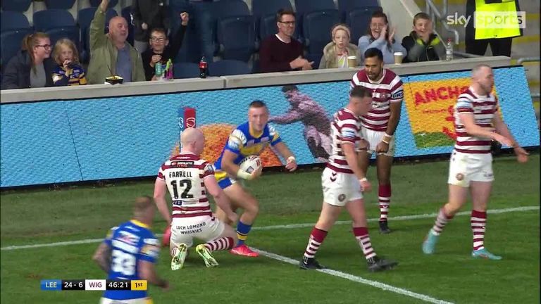 Leeds Rhinos' Harry Newman makes it 30-6 against Wigan after he dives through the legs of a Wigan defender, with the decision given by the video referee.